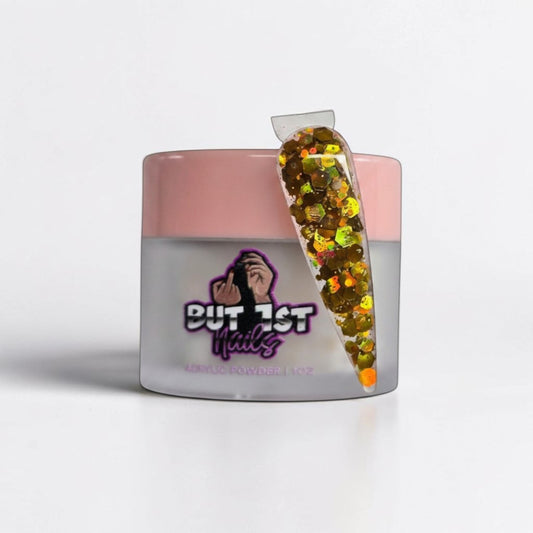 BUT 1ST NAILS Jingle Bells acrylic powder jar with a glittery gold and green nail swatch sample
